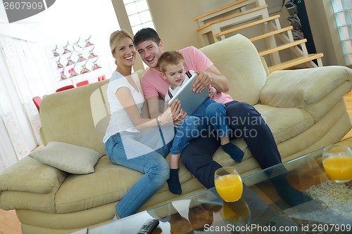 Image of family at home using tablet computer