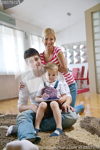 Image of family at home using tablet computer