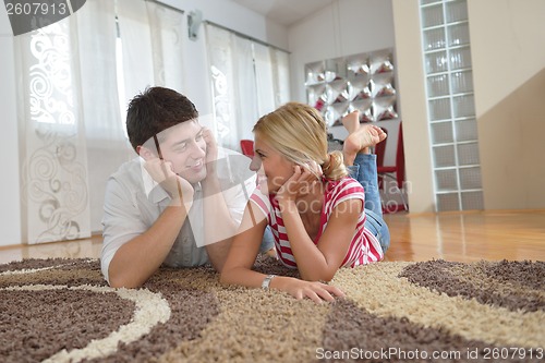 Image of Relaxed young  couple watching tv at home