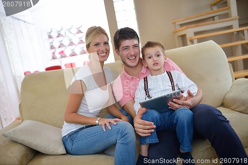 Image of family at home using tablet computer