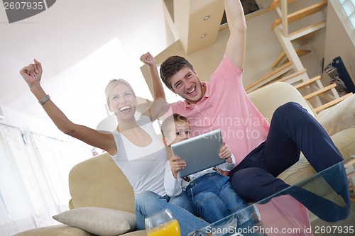 Image of family at home using tablet computer
