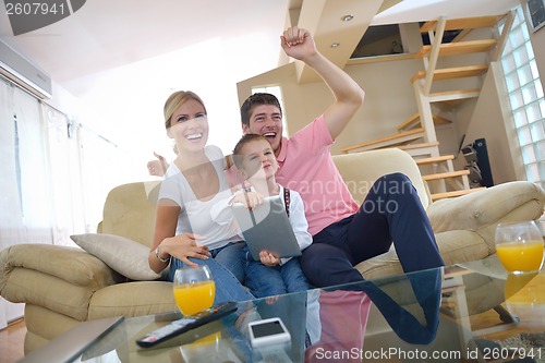 Image of family at home using tablet computer