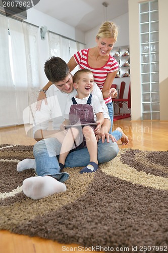 Image of family at home using tablet computer