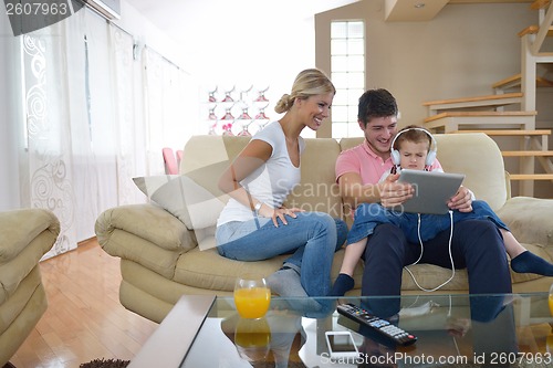Image of family at home using tablet computer