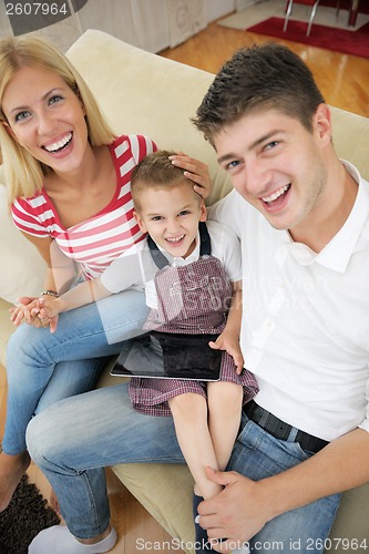 Image of family at home using tablet computer