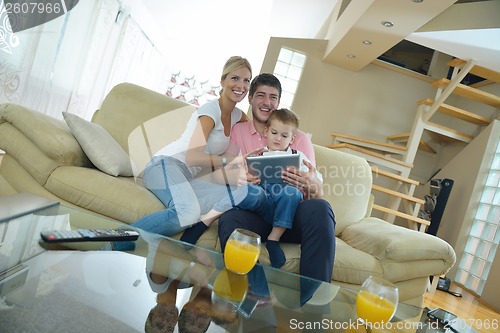 Image of family at home using tablet computer