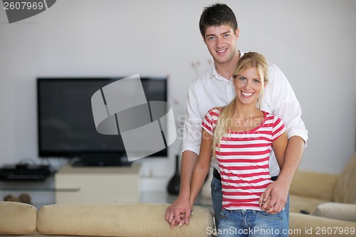 Image of Relaxed young  couple watching tv at home