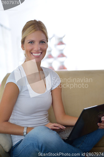 Image of woman working on laptop at home