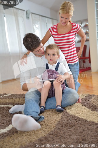 Image of family at home using tablet computer