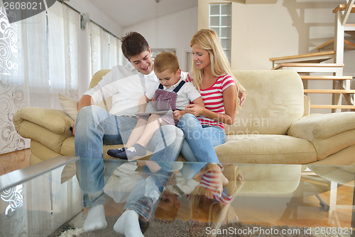 Image of family at home using tablet computer