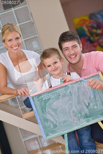 Image of family drawing on school board at home