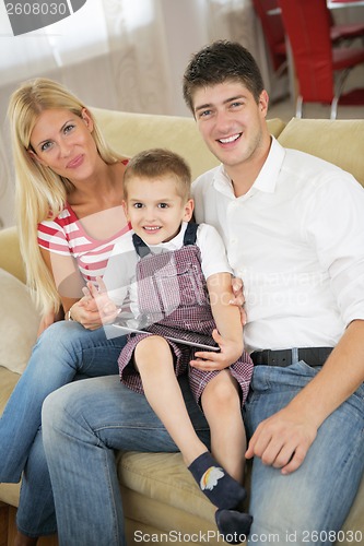 Image of family at home using tablet computer