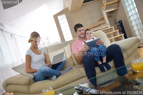 Image of family at home using tablet computer