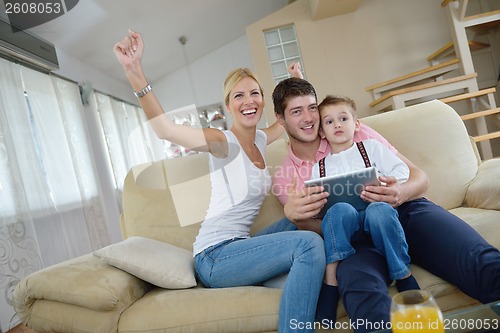 Image of family at home using tablet computer