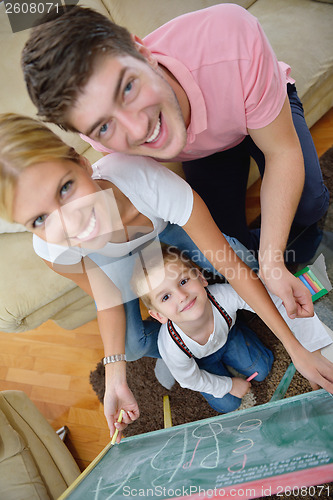 Image of family drawing on school board at home