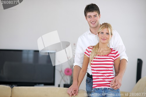 Image of Relaxed young  couple watching tv at home