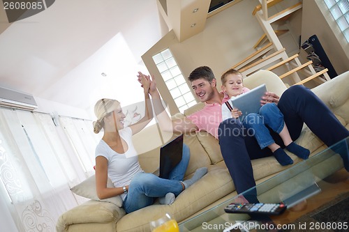 Image of family at home using tablet computer