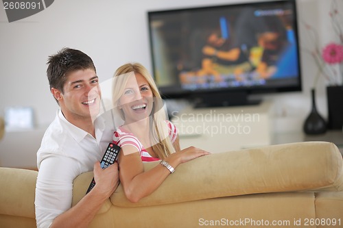 Image of Relaxed young  couple watching tv at home