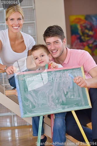 Image of family drawing on school board at home