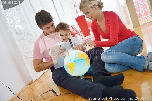 Image of family have fun with globe