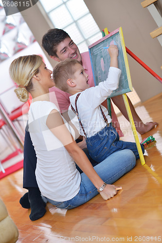 Image of family drawing on school board at home
