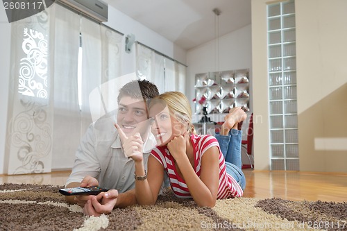 Image of Relaxed young  couple watching tv at home