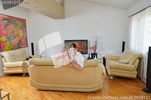 Image of Relaxed young  couple watching tv at home