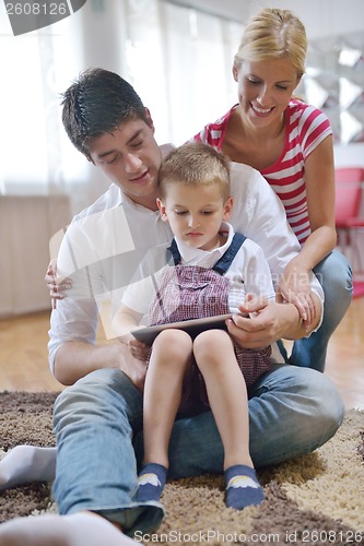 Image of family at home using tablet computer