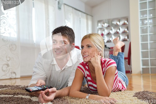 Image of Relaxed young  couple watching tv at home