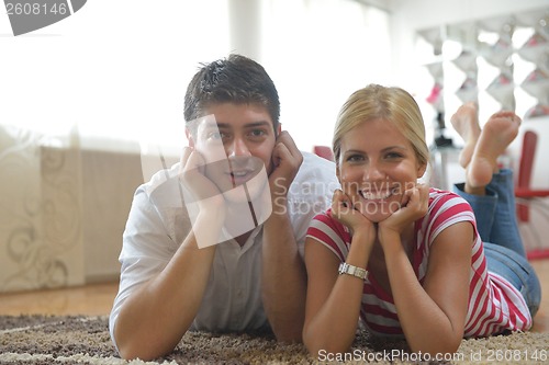 Image of Relaxed young  couple watching tv at home