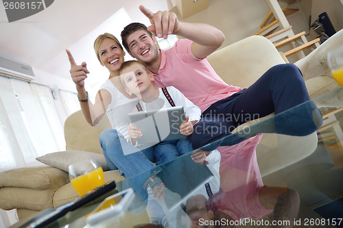 Image of family at home using tablet computer