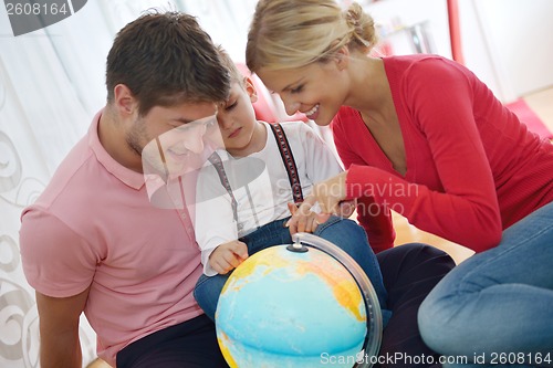 Image of family have fun with globe