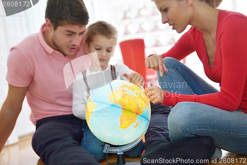 Image of family have fun with globe