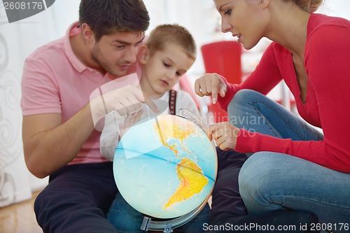 Image of family have fun with globe