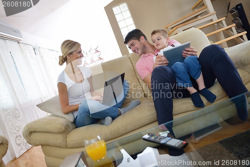 Image of family at home using tablet computer