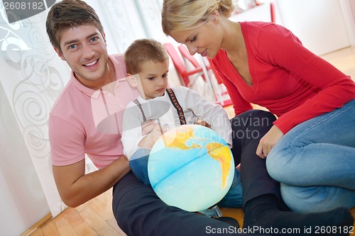 Image of family have fun with globe