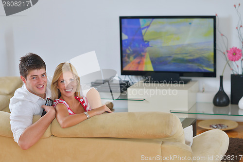 Image of Relaxed young  couple watching tv at home