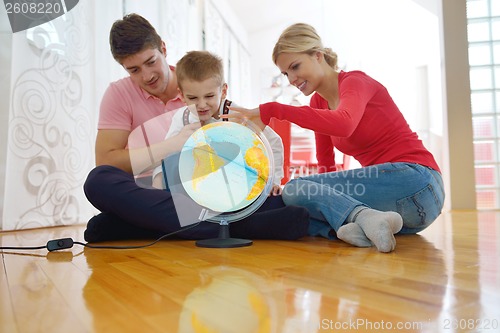 Image of family have fun with globe