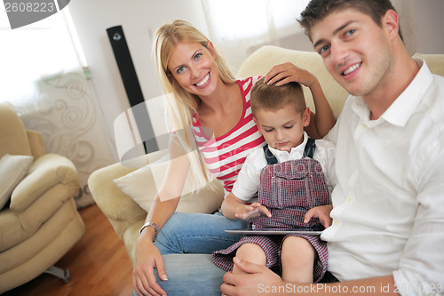 Image of family at home using tablet computer