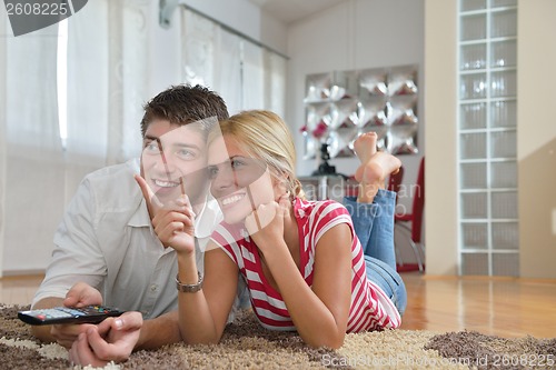 Image of Relaxed young  couple watching tv at home