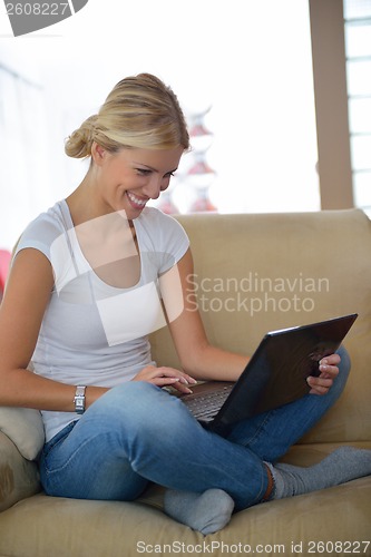 Image of woman working on laptop at home