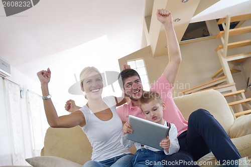 Image of family at home using tablet computer