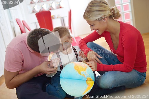 Image of family have fun with globe