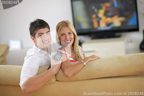 Image of Relaxed young  couple watching tv at home