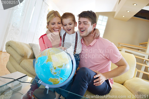 Image of family have fun with globe