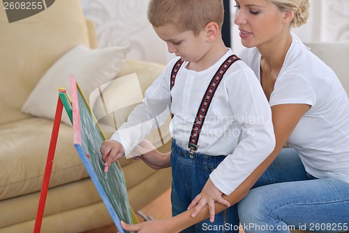 Image of family drawing on school board at home