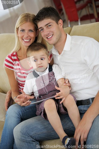 Image of family at home using tablet computer