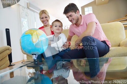 Image of family have fun with globe