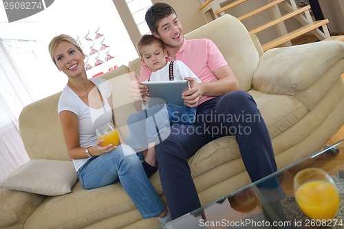 Image of family at home using tablet computer