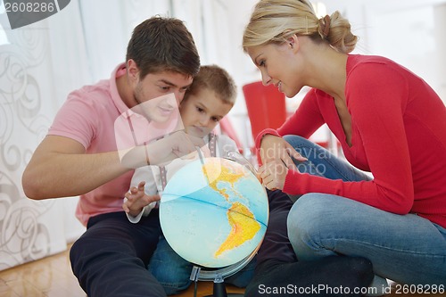 Image of family have fun with globe